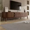 A modern living room with a TV stand and a TV mounted on the wall. Podgląd zdjęcia produktu