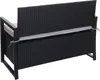 The back view of a black poly-rattan storage bench with a gray cushion. Voir les images du produit