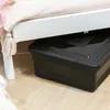 A black storage box with a lid is placed under a white bed frame. Anteprima dell’immagine prodotto