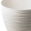 A close-up view of a white textured pot. Produktbild-Vorschau