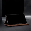A brown leather flip-style phone case is shown standing upright with a black smartphone inside, against a dark background. Produktbild-Vorschau