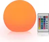 A round, orange LED light and a remote control are shown on a white background. Podgląd zdjęcia produktu