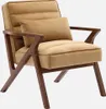 A camel-colored velvet armchair with a wooden frame, shown against a light gray background. Produktbild-Vorschau