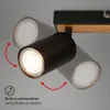 A close-up shot of a black, multi-headed ceiling spotlight with a wooden accent, mounted on a track. Produktbild-Vorschau