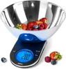 A digital kitchen scale with a stainless steel bowl filled with berries, placed on a white background. Some berries are scattered around the scale. Produktbild-Vorschau