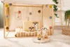 A child's play tent or bed with stuffed meerkat toys. Produktbild-Vorschau