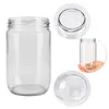 A clear glass jar is shown from multiple angles, including a full view, a top-down view of the opening, and a bottom view. A hand is shown holding a similar jar in one of the inset images. Podgląd zdjęcia produktu