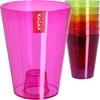 A pink KADAX flower pot with a stack of colorful flower pots in the background. Anteprima dell’immagine prodotto