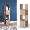 A tall, narrow shelf unit with open cubbies, set against a blue wall on the left and a white background on the right. It's made of a wood-grain material and appears to be a rotating shelf unit. Náhled obrázku produktu