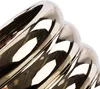 A close-up of a shiny, ribbed metallic object, possibly a decorative pot or vase, against a white background. Náhled obrázku produktu