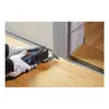 A person wearing gloves is using an oscillating multi-tool to cut along the edge of a door frame, with wooden flooring visible. Produktbild-Vorschau