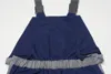 Close-up view of the back of dark blue overalls with gray elastic waistband and gray straps. Produktbild-Vorschau