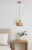 A modern pendant light hangs above a bedside table with a vase of greenery. Produktbild-Vorschau