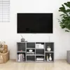 A TV stand with a TV mounted above it, in a room setting with a plant and a teddy bear. Náhled obrázku produktu