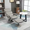 A living room scene with a gray recliner chair and ottoman, a small round table with a plant, and a bookshelf. Produktbild-Vorschau
