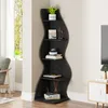 A black, wavy corner shelf unit displaying various decorative items and books. Podgląd zdjęcia produktu