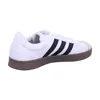A side view of a white Adidas sneaker with black stripes and a brown sole. Anteprima dell’immagine prodotto