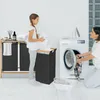 A girl and a woman are doing laundry in a laundry room. Náhled obrázku produktu