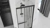 A modern bathroom with a black framed shower door and shower head. Anteprima dell’immagine prodotto