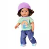 A full-body shot of a doll wearing a purple beanie, a green and white checkered t-shirt with a graphic, and blue jeans. Produktbild-Vorschau
