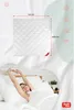 A woman stretching in bed with a product image and dimensions shown above. Produktbild-Vorschau