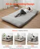 A person sleeping on a folded mattress, with smaller images showing the mattress in different configurations. Voir les images du produit