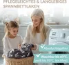 A mother and daughter are folding laundry in a bright, modern laundry room. Produktbild-Vorschau