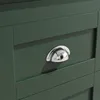 A close-up view of a dark green cabinet or drawer with a silver cup handle. Náhľad obrázku produktu