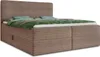 A brown corduroy boxspring bed with a green duvet and blue pillows, shown from a side angle. Produktbild-Vorschau