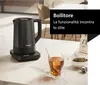 A black electric kettle is shown on a marble countertop next to a glass of tea and a bag of tea leaves. Podgląd zdjęcia produktu