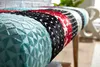 A close-up view of a colorful, patchwork upholstered bench. Produktbild-Vorschau