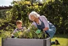A woman and a child are gardening in a raised planter. Náhľad obrázku produktu