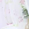A close-up view of a sheer curtain with a floral pattern. Produktbild-Vorschau