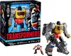 A product shot of a Transformers Studio Series action figure set, including the main Grimlock figure and a smaller Autobot Wheelie figure, displayed next to its packaging. Náhľad obrázku produktu
