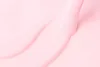 A close-up abstract view of a pink liquid product, likely a gel or cream, with smooth, flowing curves. Náhled obrázku produktu