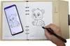 A person's hand is using a stylus to draw a panda in a notebook, with a smartphone displaying the same panda image next to it. Náhľad obrázku produktu