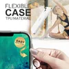 A hand is holding a clear phone case over a phone screen, with a woman doing yoga in the background. Produktbild-Vorschau