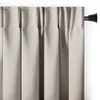 A close-up view of a light beige curtain hanging from a black curtain rod. Produktbild-Vorschau