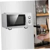 A microwave is shown mounted on a wall, with a person washing dishes in the background. Produktbild-Vorschau