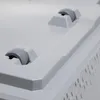 A close-up view of the bottom of a white plastic storage box, showing two gray wheels and part of a textured side. Produktbild-Vorschau