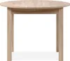A light brown, round dining table with four legs, shown from the front on a white background. Voir les images du produit