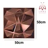 A 3D geometric wall panel with a bronze finish, shown on a white background with size indicators and a brand logo. Produktbild-Vorschau