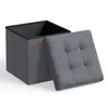 A gray storage ottoman with its lid open, showing the black interior. Produktbild-Vorschau