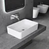 A modern bathroom with a rectangular vessel sink on a dark gray countertop, a wall-mounted faucet, and a backlit mirror. A toilet and bidet are visible in the background. Produktbild-Vorschau
