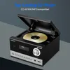 A black Medion micro audio system with a CD player open and a CD inside, placed on a gray surface with a dark gray background. Produktbild-Vorschau