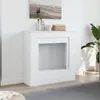 A white fireplace surround is shown in a room with a painting above it and a plant to the side. Voir les images du produit