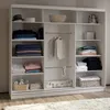 A white wardrobe with shelves and hanging space, filled with folded clothes, baskets, and a suitcase. Produktbild-Vorschau