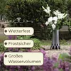 A vase with flowers on a grave. Produktbild-Vorschau