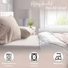 A bedroom scene with bedding, a lamp, and a window. Produktbild-Vorschau