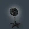 A black pedestal fan is shown against a dark gray background. Voir les images du produit